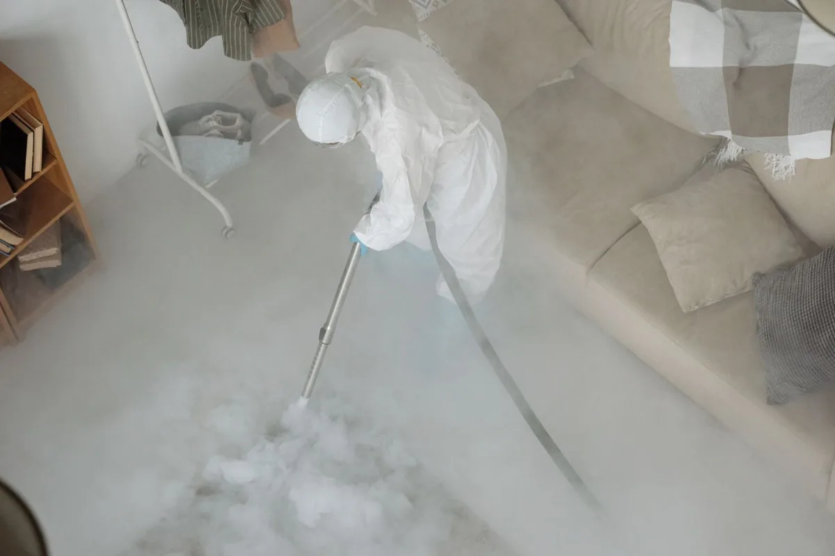 Biohazard cleanup technician in protective equipment, Dedham, MA